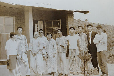 Korean female doctor with patients in front of the tuberculosis sanatorium.