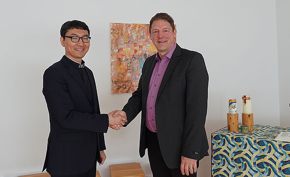 Der neue EMS Fachbereichsleiter Ostasien und der Abteilungsleiter Regionen und Missionsvereine geben sich zur Begrüßung die Hand. 